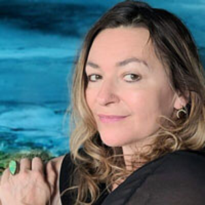 A woman holding onto a green object in her hand.