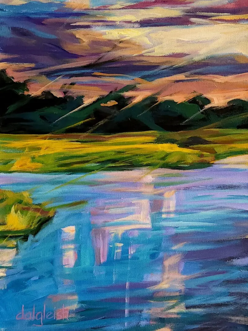 Vibrant landscape with water and colorful sky.