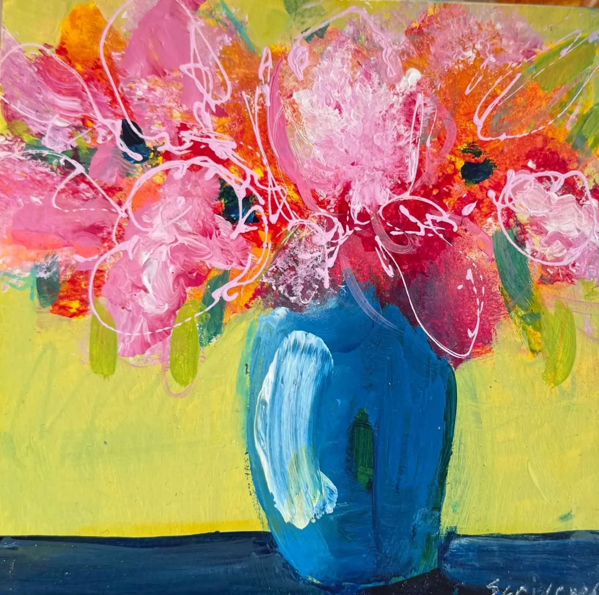 Colorful abstract flowers in blue vase.